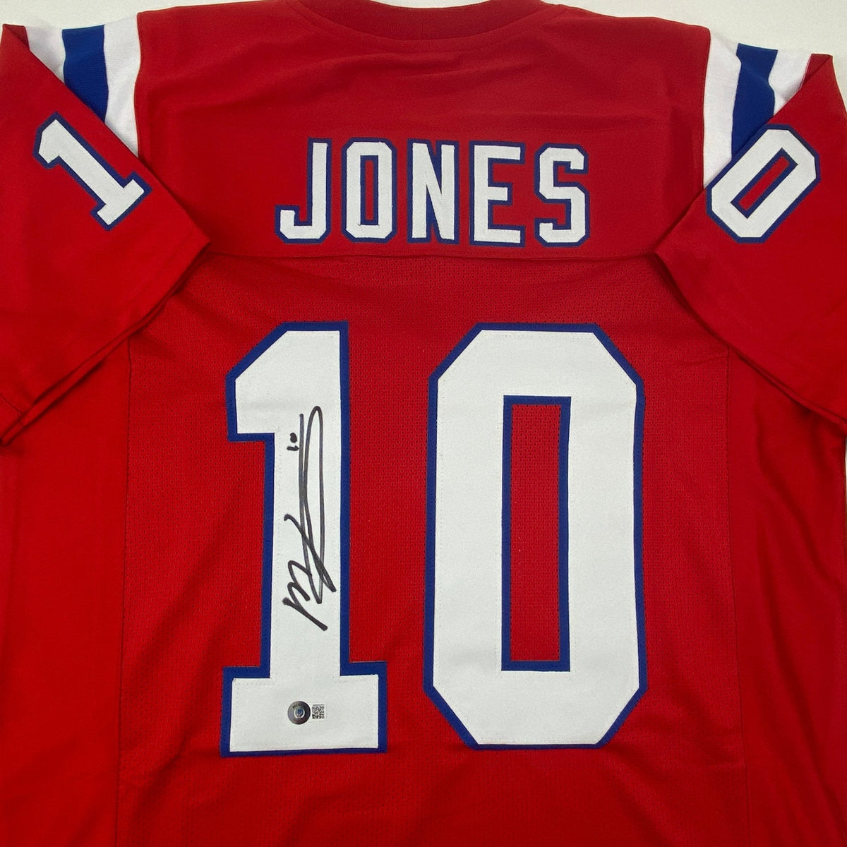 Autographed/Signed Mac Jones New England Red Football Jersey Beckett BAS COA