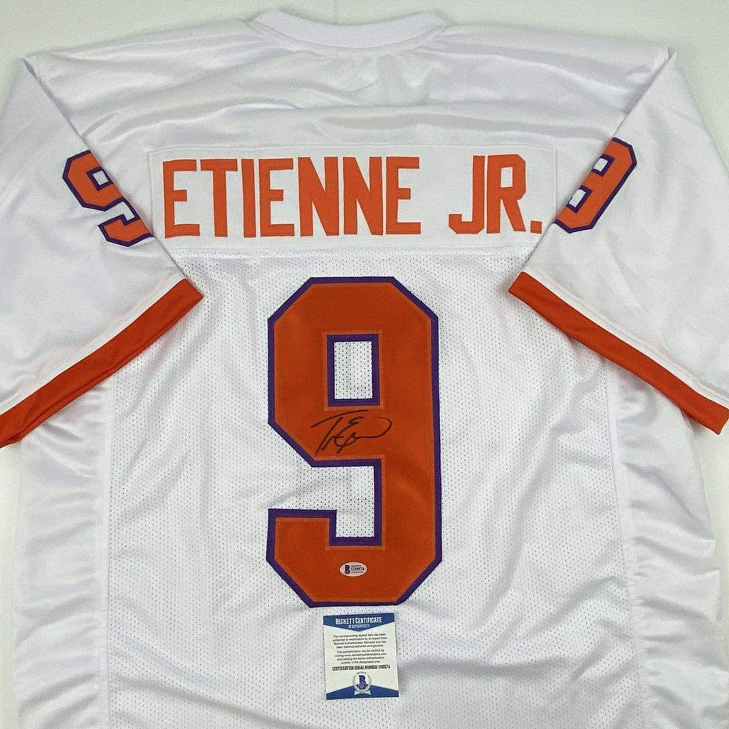 Autographed/Signed Travis Etienne Jr. Clemson White College Football Jersey Beckett BAS COA
