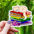 Cat Sleeping on top of Pride Books Sticker - 3"