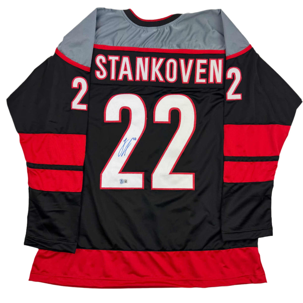 Autographed/Signed Logan Stankoven Carolina Black Hockey Jersey Beckett BAS COA